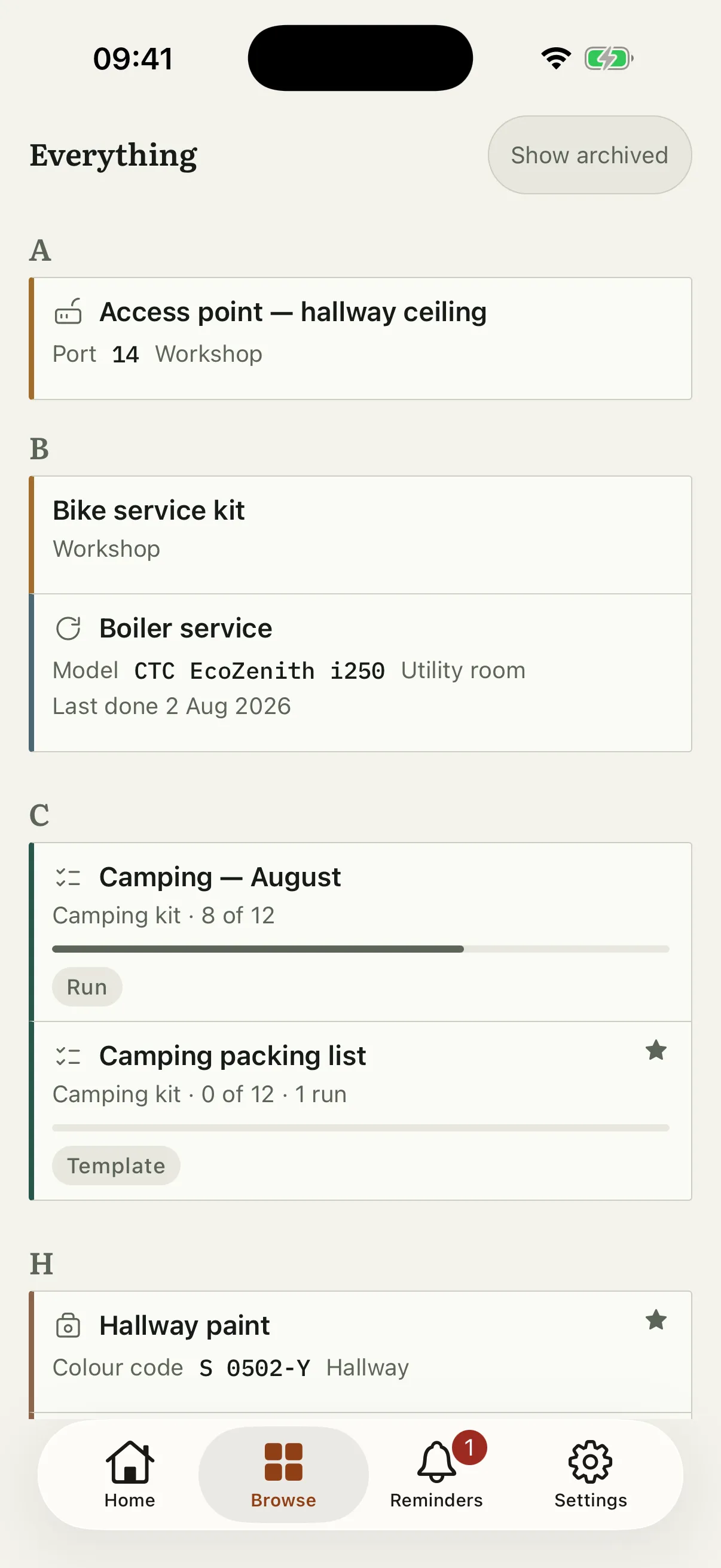 The browse screen listing everything in one alphabetical list, each row naming which room or collection it belongs to — an access point in the Workshop, the boiler service in the Utility room, a camping run in Camping kit, the hallway paint in the Hallway.